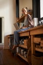 Woman in kitchen, laptop and remote work, thinking of ideas for blog, freelancer and copywriting. Working from home Royalty Free Stock Photo