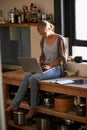 Woman in kitchen, laptop and remote work, typing for blog with freelancer and copywriting. Working from home, website Royalty Free Stock Photo