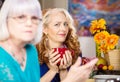 Skeptical Woman drinking coffee with friend in kitchen