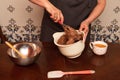 A woman in the kitchen is mixing chocolate muffin dough. making cake at home Royalty Free Stock Photo