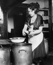 Woman in a kitchen peeling potatoes Royalty Free Stock Photo