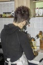 Woman in kitchen, preparing meal ,uk