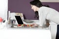 Woman in kitchen reading recipe