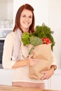 Woman, kitchen and vegetables from grocery shopping, smile and food with nutrition, organic and cooking. Healthy, home