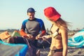 Woman kitesurfer enjoying summertime on sandy beach with her boyfriend. Royalty Free Stock Photo