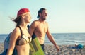 Woman kitesurfer enjoying summertime on sandy beach with her boyfriend. Royalty Free Stock Photo