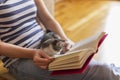 Woman and kitten reading a book Royalty Free Stock Photo