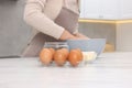 Woman kneading dough in bowl at white table, closeup Royalty Free Stock Photo