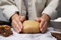 Woman kneading dough for cookies at white marble table, closeup Royalty Free Stock Photo