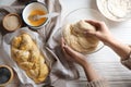 Woman kneading dough at white wooden table in kitchen, top view. Cooking traditional Shabbat challah Royalty Free Stock Photo