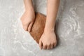 Woman kneading fresh dough on table top view Royalty Free Stock Photo