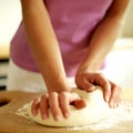 Woman kneading pizza dough