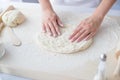 Woman kneading pizza dough on wooden pastry board. Royalty Free Stock Photo