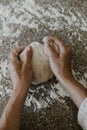 Woman kneading sourdough in her kitchen during quarantine