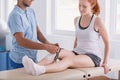 Woman with a knee injury during a therapy with kinesiotaping Royalty Free Stock Photo