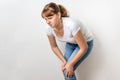 Woman with knee pain is holding her aching leg Royalty Free Stock Photo
