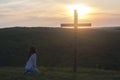 Repentance. A woman is kneeling. Near the cross. Prayer of repentance. Christian faith. Royalty Free Stock Photo