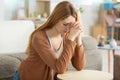 Woman kneeling in prayer in living room