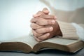 woman kneeling and praying in modern house at sunset time. Female catholic prayer worship to God wish a better life in home at Royalty Free Stock Photo