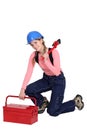 Woman kneeling by tool box