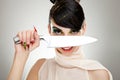 Woman with a knife over her face