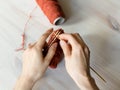 Woman knits a pattern on table