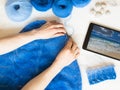 Woman knits a pattern on table