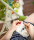 A woman knits a white canvas with spokes. Hands close-up. Royalty Free Stock Photo