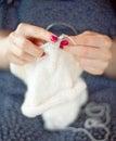 A woman knits a white canvas with spokes. Hands close-up. Royalty Free Stock Photo