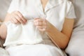 A woman knits in white wool. Royalty Free Stock Photo