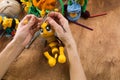 A woman knits a wool toy with hook. Hands close-up