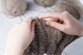 The woman knits woolen clothes. Knitting needles. Close-up. natural wool Royalty Free Stock Photo