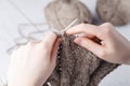 The woman knits woolen clothes. Knitting needles. Close-up. natural wool Royalty Free Stock Photo