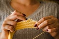 The woman knits woolen clothes. Knitting needles Royalty Free Stock Photo
