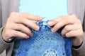 Woman knitting blue pattern closeup