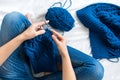 Woman knitting blue sweater