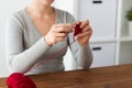 Woman knitting with crochet hook and red yarn Royalty Free Stock Photo