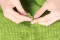 Woman knitting green woolen threads closeup Royalty Free Stock Photo