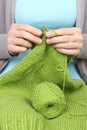 Woman knitting green woolen threads closeup Royalty Free Stock Photo