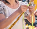 A woman knitting his Easter whip from a rod