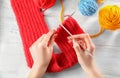 Woman knitting scarf at table Royalty Free Stock Photo