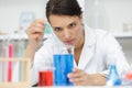 woman lab assistant with flasks with liquids