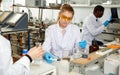 Woman lab technicians in glasses working with reagents and test tubes Royalty Free Stock Photo