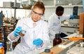 Woman lab technicians in glasses working with reagents and test tubes Royalty Free Stock Photo