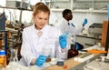 Woman lab technicians in glasses working with reagents and test tubes Royalty Free Stock Photo