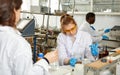 Woman lab technicians in glasses working with reagents and test tubes Royalty Free Stock Photo