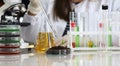 Woman in laboratory drips into soil with sprout Royalty Free Stock Photo