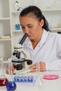 Woman in a laboratory microscope with microscope slide in hand Royalty Free Stock Photo