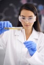 Woman, laboratory and science experiment with test tube for medical research as virus breakthrough, particles or liquid