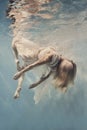 A woman in a dress swims underwater as if floating in zero gravity Royalty Free Stock Photo